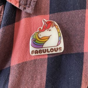 Fabulous rainbow unicorn Pride badge on a pink and blue plaid shirt