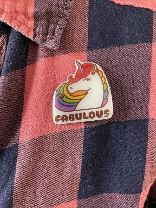 Fabulous rainbow unicorn Pride badge on a pink and blue plaid shirt